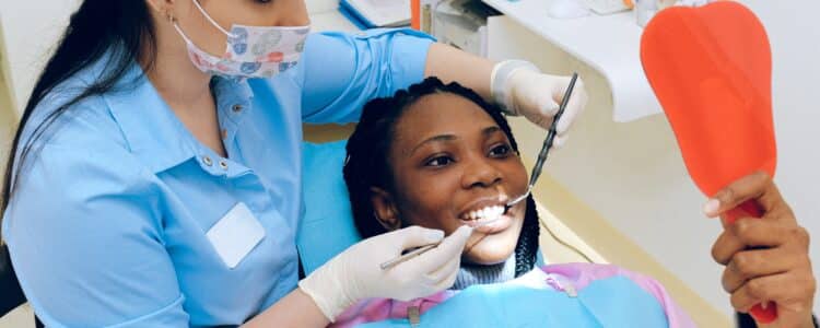 Dental Hygienist Working on Patient