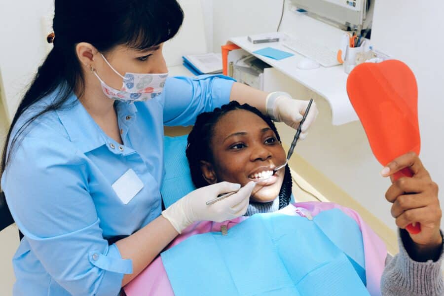 Dental Hygienist Working on Patient