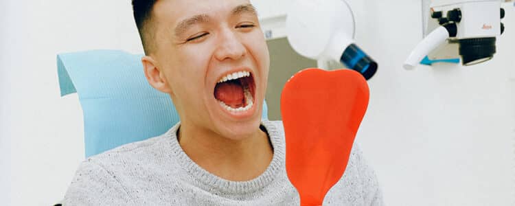 Man looking at teeth, cosmetic dentistry