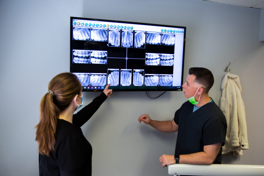 Capozzi Dental Restorative Dental Care, Dr. Capozzi reviewing patient x-ray with assistant